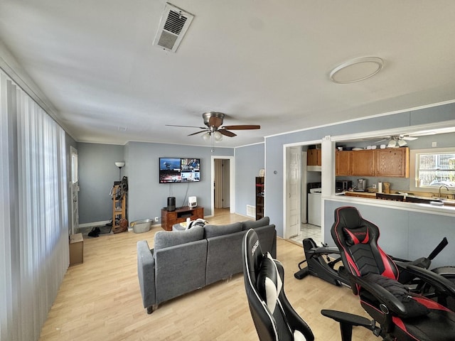 living room with ceiling fan, sink, and light hardwood / wood-style floors