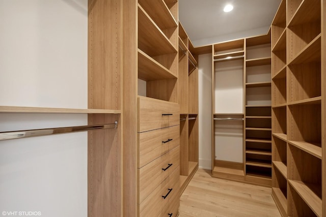 walk in closet with light wood-type flooring