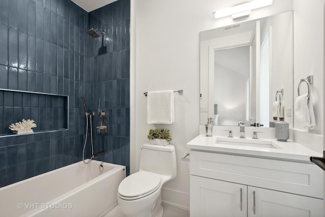 full bathroom with vanity, tiled shower / bath combo, and toilet