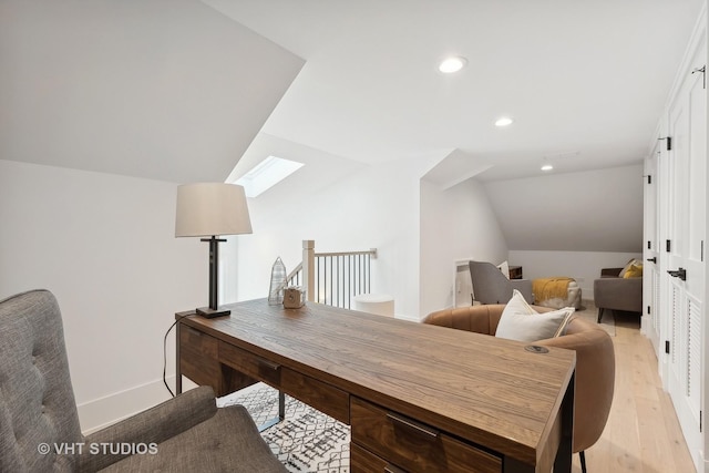 office space featuring lofted ceiling and light hardwood / wood-style flooring