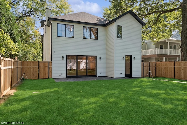 back of house featuring a yard