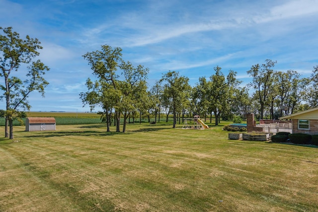 view of yard with a playground and a shed