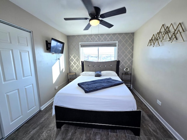 bedroom with dark hardwood / wood-style floors and ceiling fan