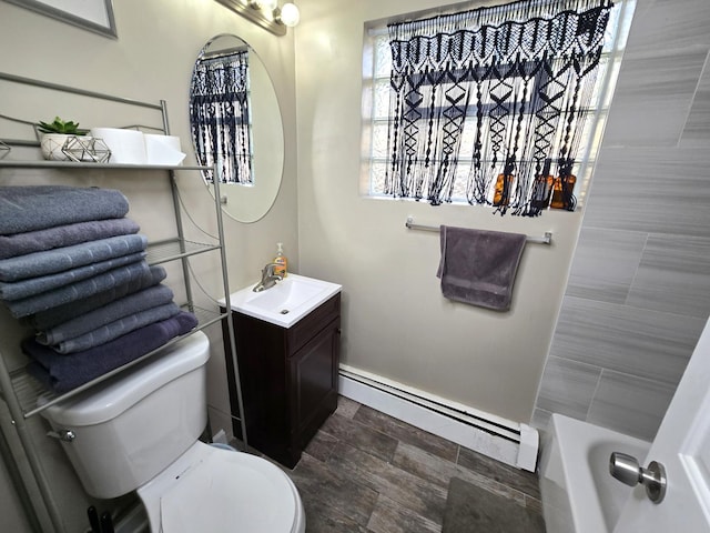 bathroom with vanity, toilet, and a baseboard radiator