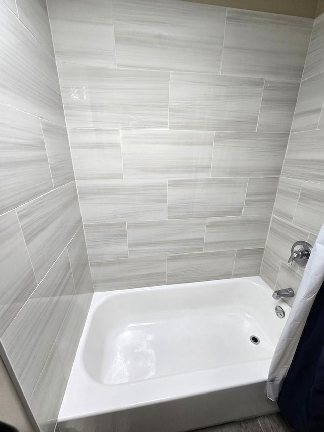 bathroom with shower / bath combination with curtain