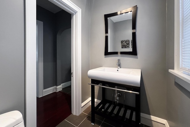 bathroom with tile patterned flooring, sink, and toilet