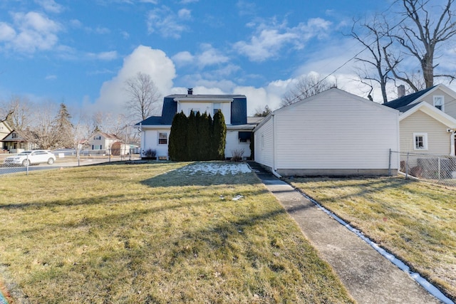 rear view of house featuring a lawn