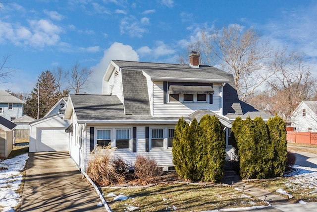 view of front of home featuring a garage and an outdoor structure