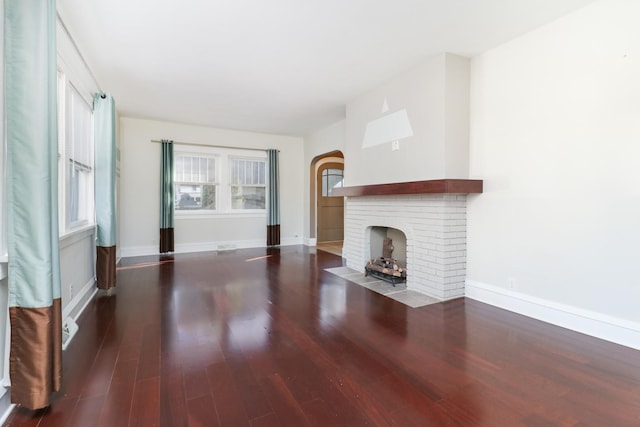 unfurnished living room featuring dark hardwood / wood-style flooring and a fireplace