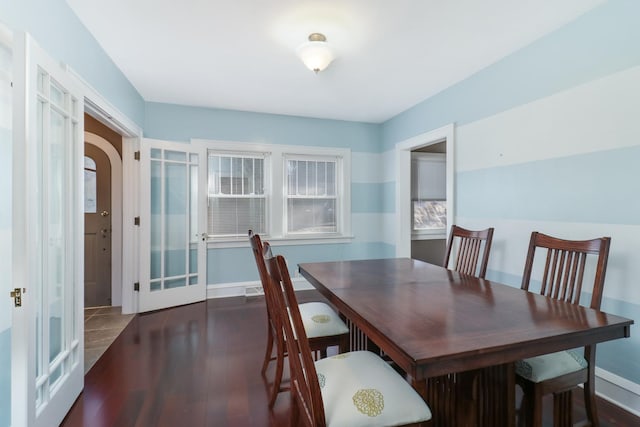 dining space featuring dark hardwood / wood-style flooring and french doors