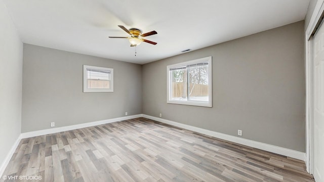 empty room with ceiling fan and light wood-type flooring