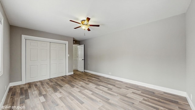 unfurnished bedroom featuring ceiling fan, a closet, and light hardwood / wood-style floors