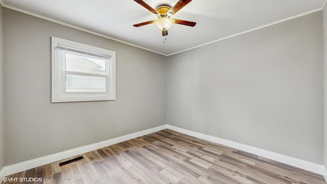 empty room featuring light hardwood / wood-style flooring, ceiling fan, and crown molding