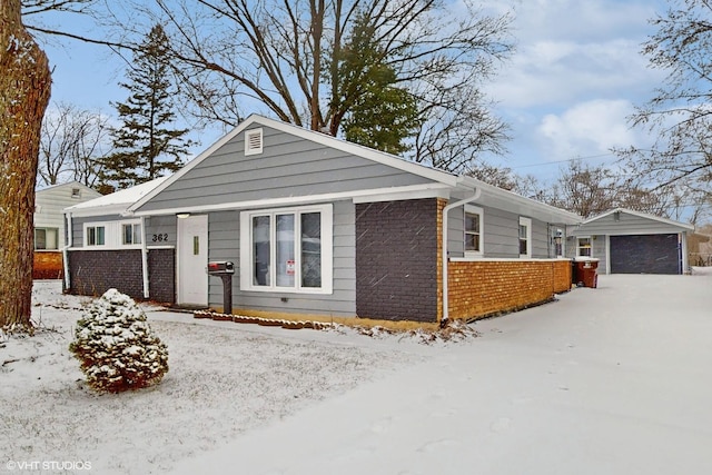 view of front of property with a garage and an outdoor structure