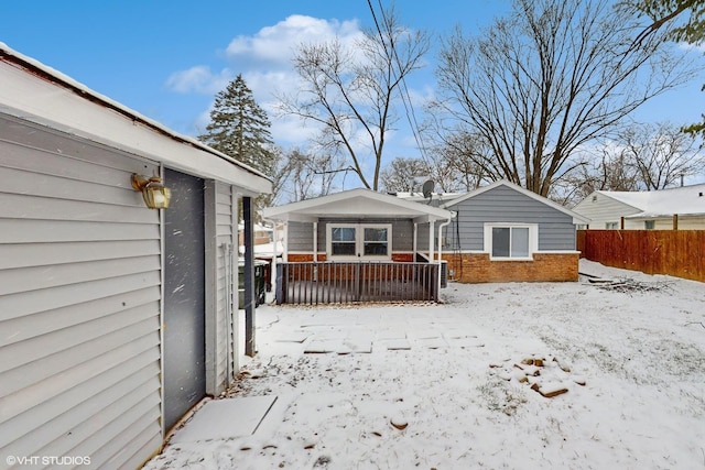 snow covered house with covered porch