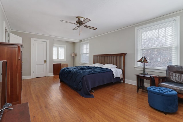 bedroom with ceiling fan, ornamental molding, and light hardwood / wood-style flooring