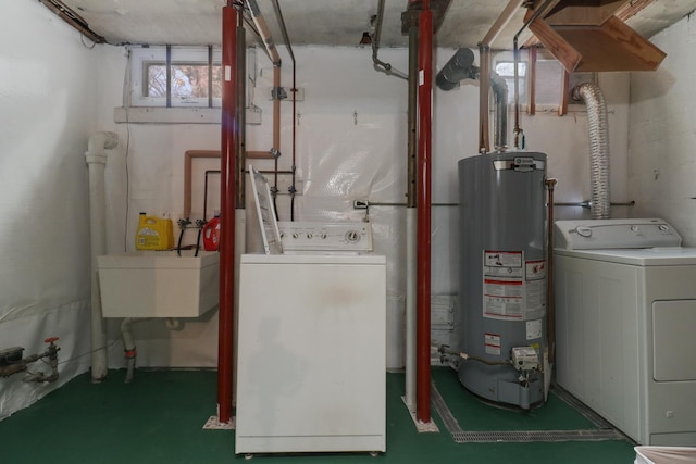 interior space with separate washer and dryer, sink, and gas water heater