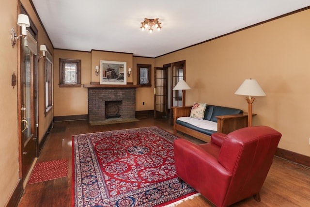 living room with dark wood-type flooring, crown molding, and a brick fireplace