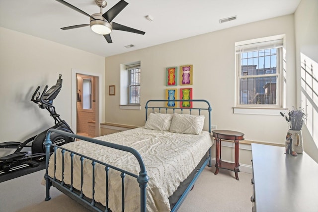 bedroom with ceiling fan and light colored carpet