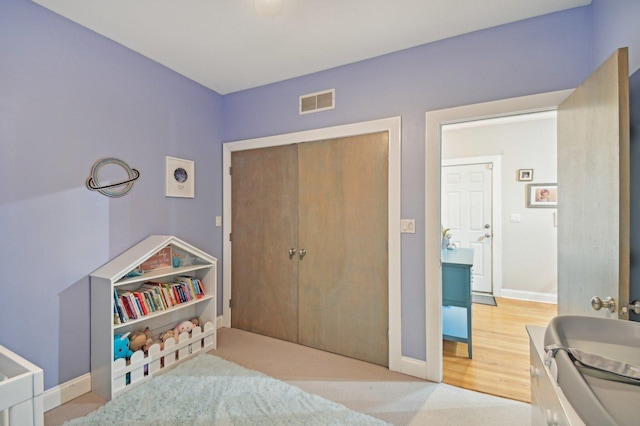 carpeted bedroom with a closet