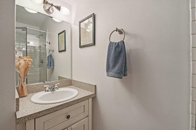 bathroom with vanity and a shower with shower door