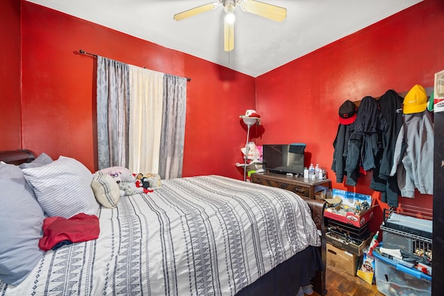 bedroom with ceiling fan and wood-type flooring