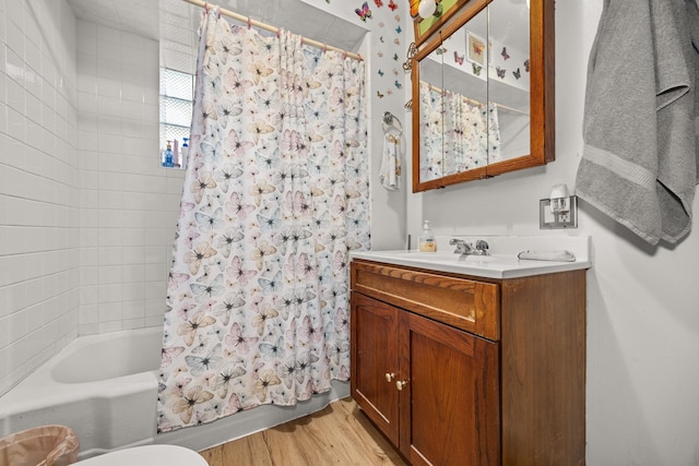 full bathroom with shower / bath combination with curtain, toilet, vanity, and hardwood / wood-style flooring