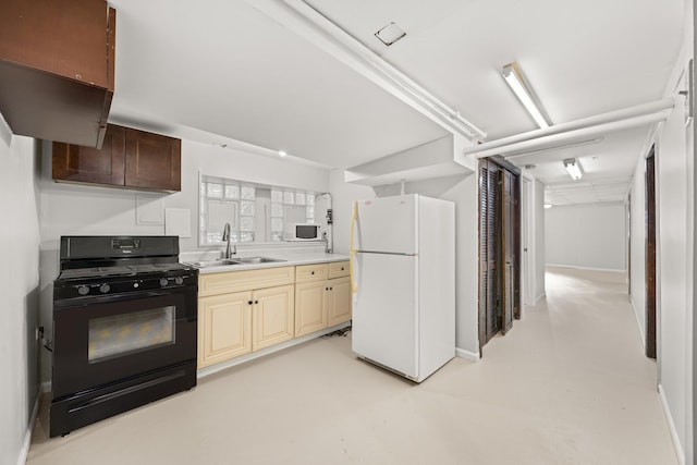 kitchen featuring white appliances, cream cabinetry, and sink