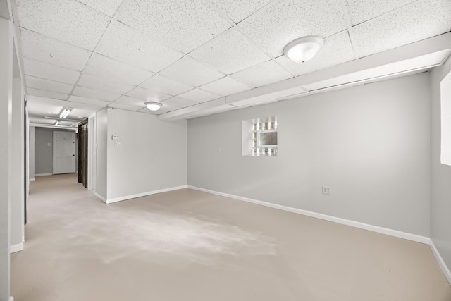 basement with a paneled ceiling