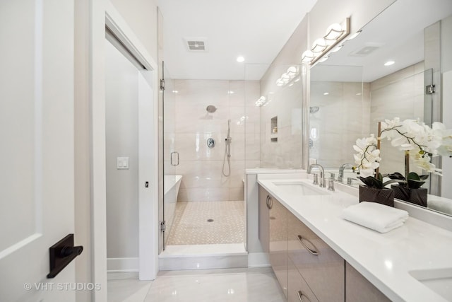 bathroom with tile patterned flooring, vanity, and a shower with shower door