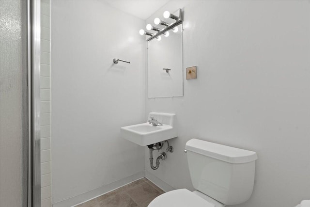 bathroom with tile patterned floors and toilet