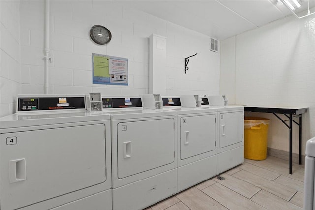 clothes washing area with washing machine and clothes dryer