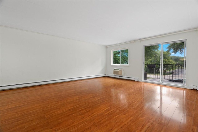 spare room with an AC wall unit and wood-type flooring