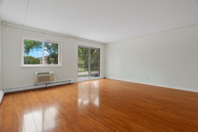 unfurnished room with light hardwood / wood-style flooring, a wall unit AC, and a baseboard radiator