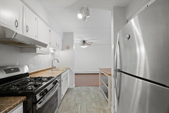 kitchen with white cabinets, sink, light hardwood / wood-style flooring, ceiling fan, and appliances with stainless steel finishes