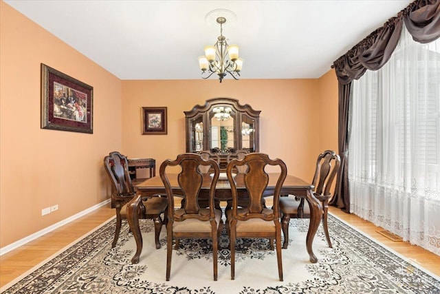 dining room with a notable chandelier and hardwood / wood-style floors