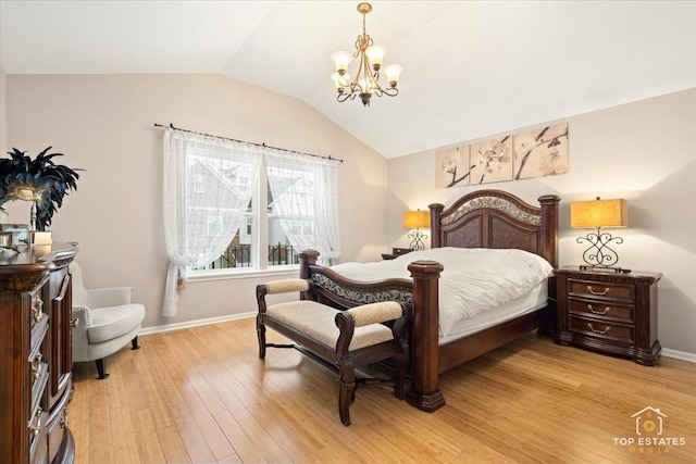 bedroom with lofted ceiling, a notable chandelier, and light hardwood / wood-style floors