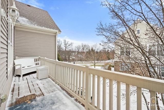 view of snow covered back of property