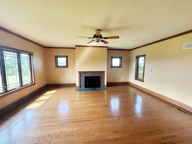 unfurnished living room with ceiling fan, wood-type flooring, and ornamental molding