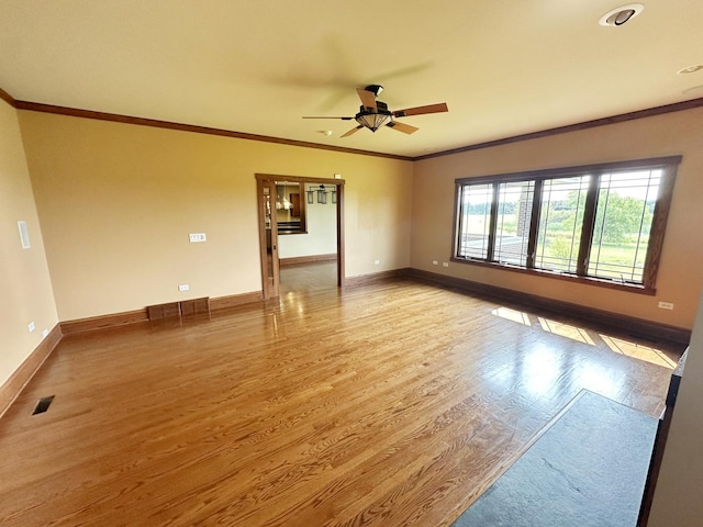 spare room with ceiling fan, crown molding, and light hardwood / wood-style flooring