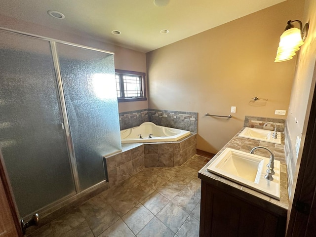 bathroom featuring tile patterned flooring, vanity, and shower with separate bathtub