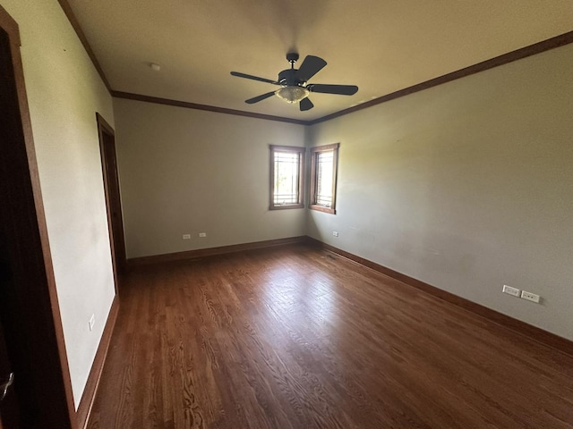 spare room with dark hardwood / wood-style flooring, ceiling fan, and crown molding