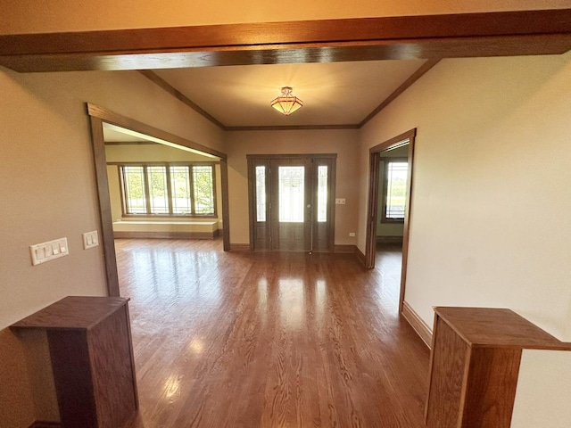 foyer with wood-type flooring and ornamental molding