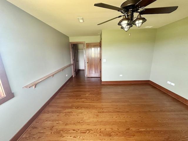 empty room featuring hardwood / wood-style floors and ceiling fan