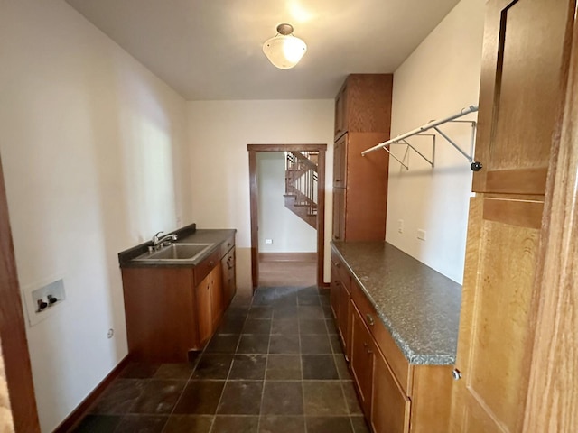 interior space with cabinets, washer hookup, and sink