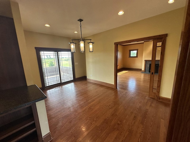 unfurnished dining area featuring wood-type flooring