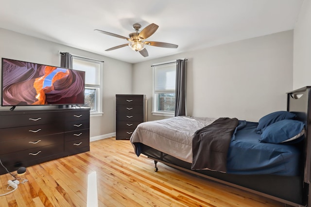 bedroom with ceiling fan and light hardwood / wood-style floors