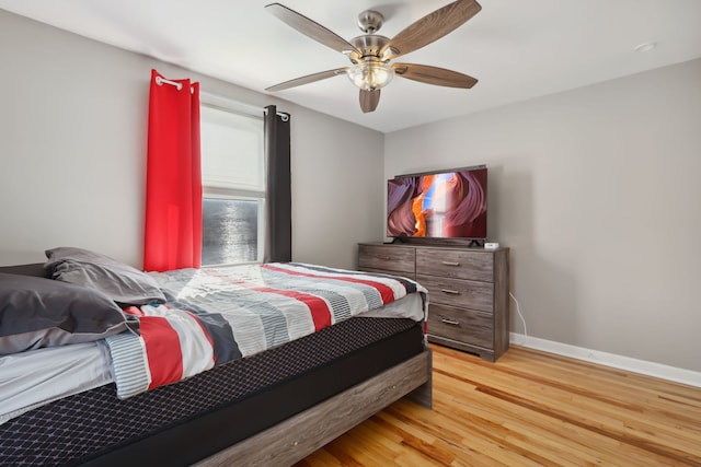 bedroom with ceiling fan and hardwood / wood-style flooring