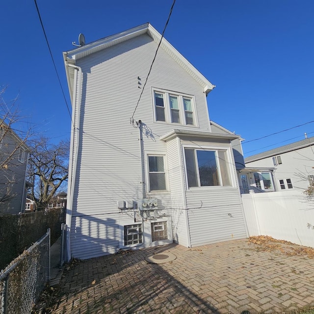 rear view of property featuring a patio area