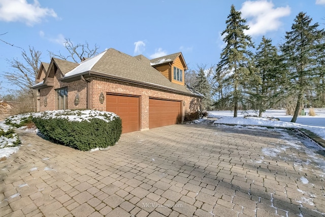 snow covered property featuring a garage